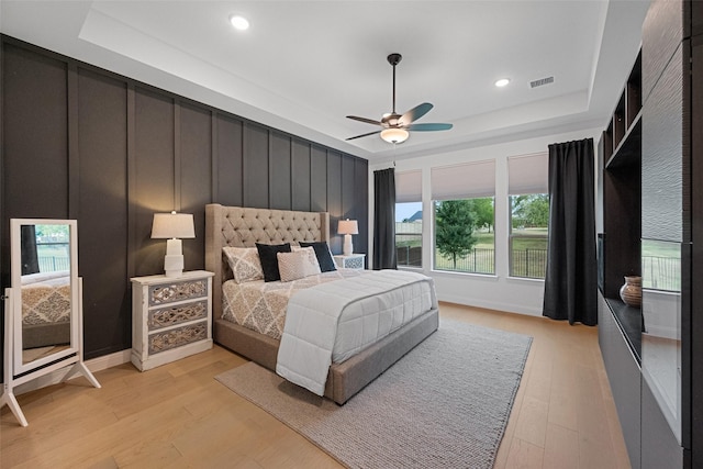 1804 Rockwood Ln, Mansfield, TX 76063 - bedroom with light wood-type flooring, a tray ceiling, recessed lighting, and a ceiling fan