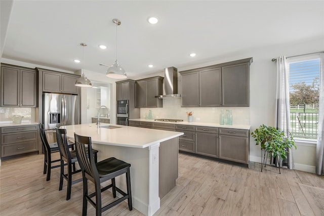 10020 Crestview Dr, Denton, TX 76207 - kitchen featuring wall chimney range hood, a sink, appliances with stainless steel finishes, tasteful backsplash, and a kitchen breakfast bar
