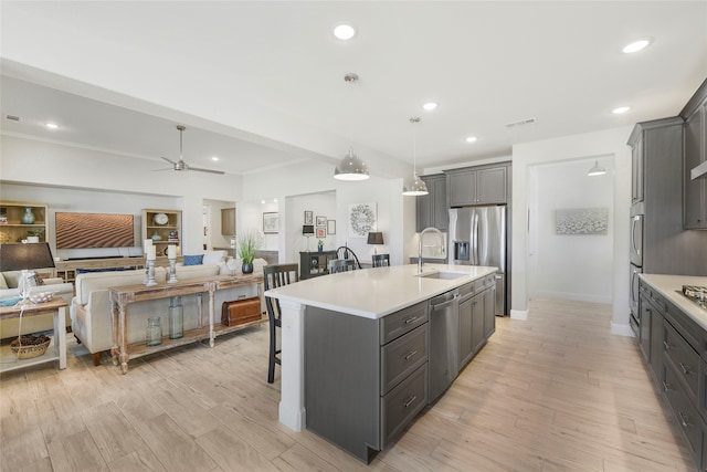10020 Crestview Dr, Denton, TX 76207 - kitchen featuring a sink, appliances with stainless steel finishes, light countertops, a breakfast bar, and ceiling fan