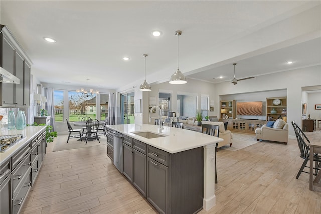 10020 Crestview Dr, Denton, TX 76207 - kitchen with a sink, light countertops, a chandelier, light wood-style flooring, and ceiling fan