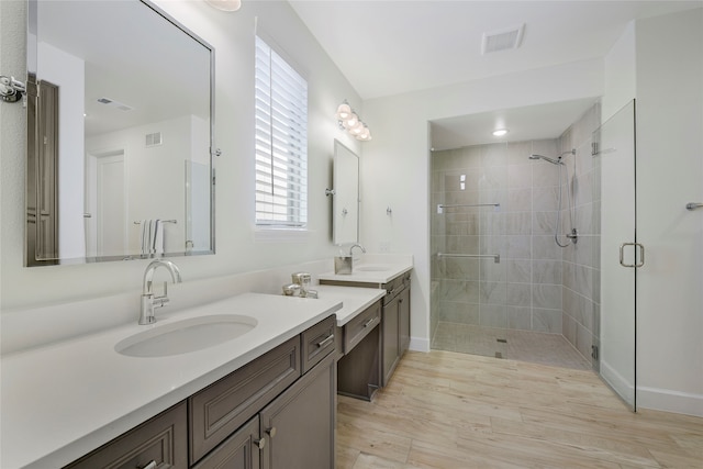 10020 Crestview Dr, Denton, TX 76207 - full bathroom featuring a shower stall, two vanities, wood finished floors, and baseboards