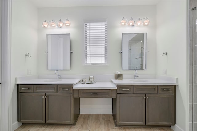 10020 Crestview Dr, Denton, TX 76207 - bathroom with two vanities, tiled shower, and wood finished floors