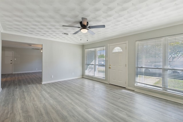 1103 Bowman St, Irving, TX 75060 - unfurnished living room with ceiling fan, baseboards, wood finished floors, and crown molding