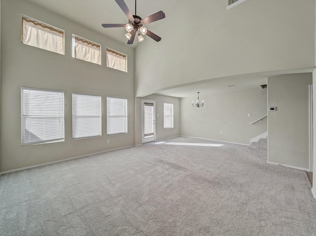 1159 Landon Ln, Allen, TX 75013 - unfurnished living room featuring a chandelier, ceiling fan, a high ceiling, carpet flooring, and stairway