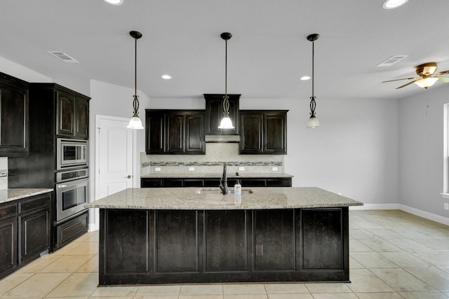 1708 Stillwater Dr, Burleson, TX 76028 - kitchen with stainless steel appliances, a sink, tasteful backsplash, light stone countertops, and recessed lighting