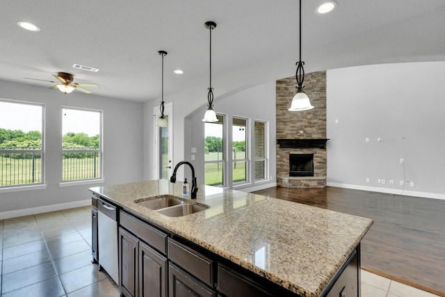 1708 Stillwater Dr, Burleson, TX 76028 - kitchen featuring a sink, stainless steel dishwasher, a kitchen island with sink, a ceiling fan, and baseboards
