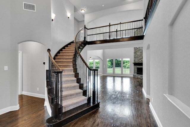 1708 Stillwater Dr, Burleson, TX 76028 - foyer with wood finished floors, arched walkways, a towering ceiling, stairway, and baseboards