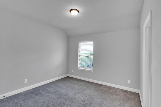 1708 Stillwater Dr, Burleson, TX 76028 - spare room featuring dark carpet, baseboards, and lofted ceiling