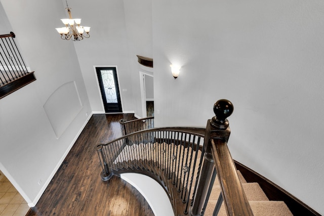 1708 Stillwater Dr, Burleson, TX 76028 - stairs with a chandelier, wood finished floors, baseboards, and a high ceiling