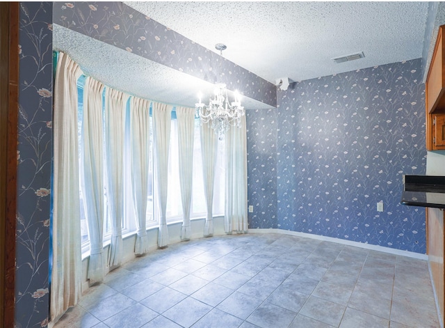 6604 Ems Ct, Fort Worth, TX 76487 - unfurnished dining area with a chandelier, wallpapered walls, baseboards, a textured ceiling, and tile patterned floors