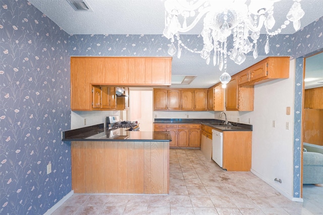 6604 Ems Ct, Fort Worth, TX 76487 - kitchen with wallpapered walls, a textured ceiling, dark countertops, dishwasher, and brown cabinetry