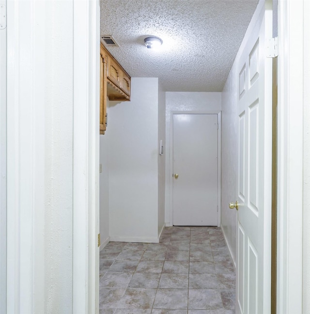 6604 Ems Ct, Fort Worth, TX 76487 - hall featuring a textured ceiling and baseboards