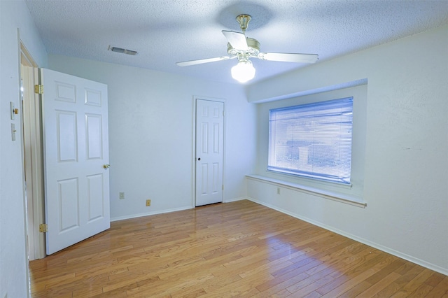 6604 Ems Ct, Fort Worth, TX 76487 - unfurnished bedroom with light wood-type flooring, a textured ceiling, baseboards, and a ceiling fan