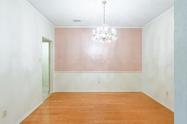 6604 Ems Ct, Fort Worth, TX 76487 - unfurnished dining area with crown molding, light wood-style floors, a chandelier, and a textured ceiling