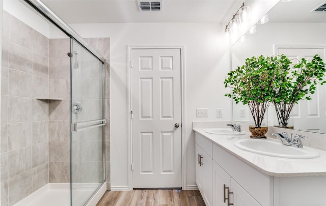 2402 Carlow Ln, Lowry Crossing, TX 75407 - full bathroom featuring double vanity, a tile shower, and wood finished floors