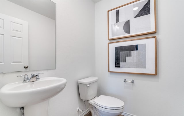 2402 Carlow Ln, Lowry Crossing, TX 75407 - bathroom featuring baseboards, toilet, and a sink