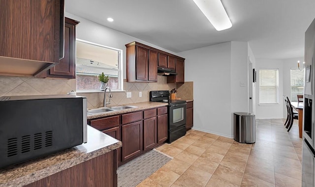 6608 Costa Dr, Waco, TX 76712 - kitchen featuring black electric range oven, a sink, under cabinet range hood, and plenty of natural light