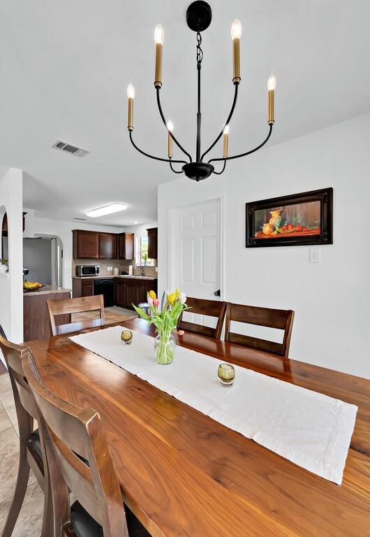 6608 Costa Dr, Waco, TX 76712 - dining room with a chandelier and arched walkways
