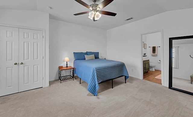 6608 Costa Dr, Waco, TX 76712 - bedroom with carpet, vaulted ceiling, a closet, a ceiling fan, and connected bathroom