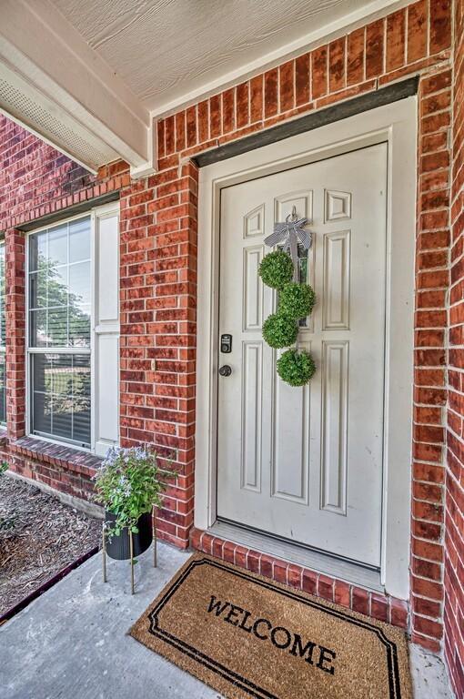 6608 Costa Dr, Waco, TX 76712 - doorway to property with brick siding