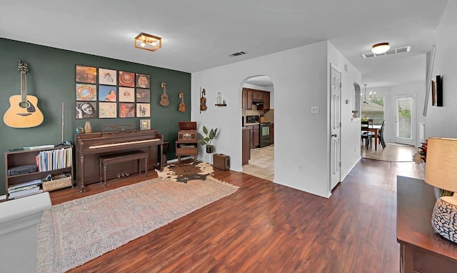 6608 Costa Dr, Waco, TX 76712 - living room featuring arched walkways and wood finished floors