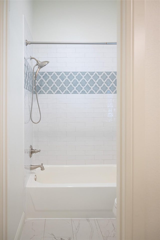 6032 Forest Ln, Fort Worth, TX 76112 - full bathroom featuring marble look tile flooring, bathing tub / shower combination, toilet, and baseboards
