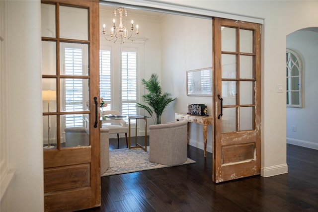 6032 Forest Ln, Fort Worth, TX 76112 - entrance foyer featuring arched walkways, a chandelier, baseboards, and dark wood-style floors