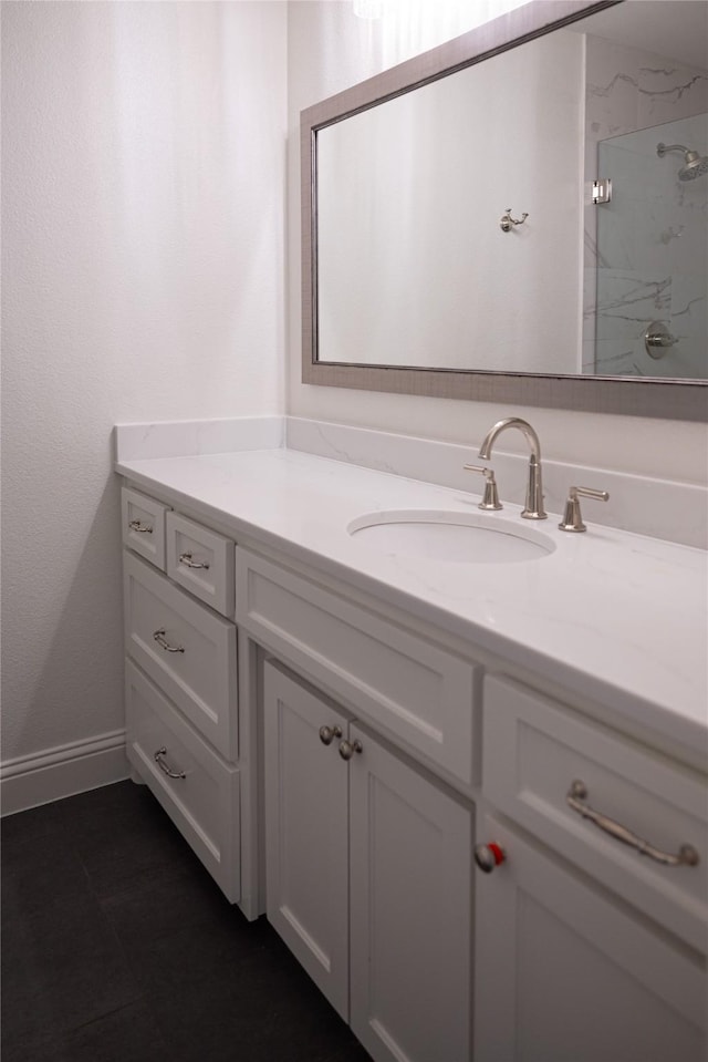 6032 Forest Ln, Fort Worth, TX 76112 - bathroom featuring vanity, a marble finish shower, and baseboards