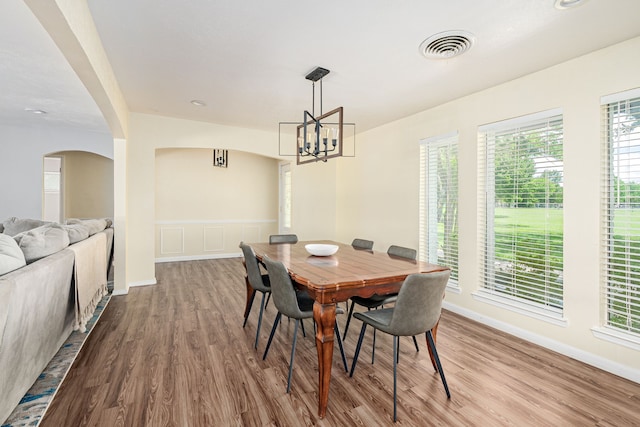 10 Estates Rd, Lucas, TX 75002 - dining room with a chandelier, wood finished floors, arched walkways, and baseboards
