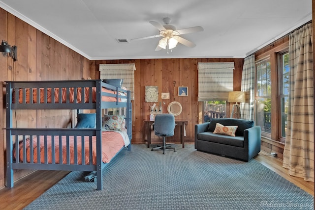 5305 S Lakeshore Dr, Shreveport, LA 71109 - bedroom featuring wooden walls, ornamental molding, and a ceiling fan