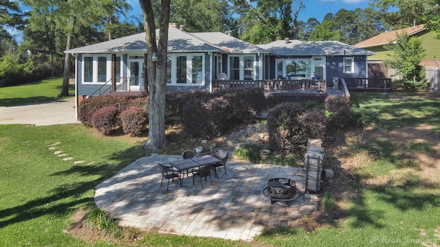 5305 S Lakeshore Dr, Shreveport, LA 71109 - rear view of property with an outdoor fire pit, a wooden deck, a lawn, a patio, and a shingled roof