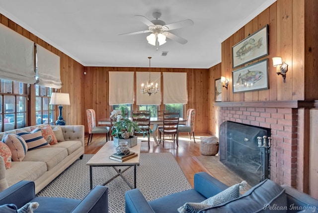 5305 S Lakeshore Dr, Shreveport, LA 71109 - living room with wooden walls, wood finished floors, ceiling fan, a chandelier, and ornamental molding