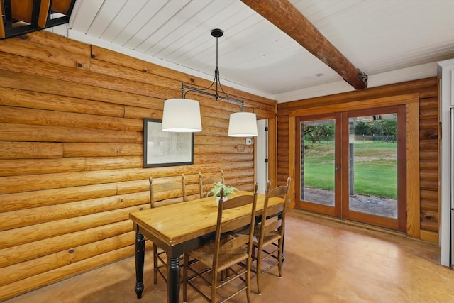 127 Pleasant Valley Ln, Weatherford, TX 76087 - dining area with finished concrete floors, beam ceiling, and rustic walls