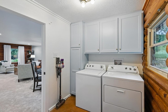 127 Pleasant Valley Ln, Weatherford, TX 76087 - laundry area featuring cabinet space, washer and clothes dryer, light colored carpet, and a textured ceiling