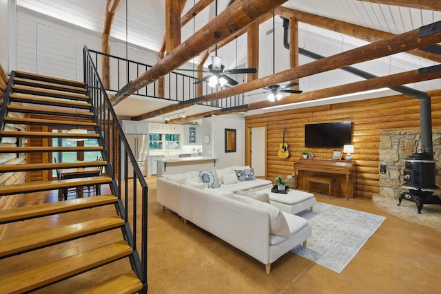 127 Pleasant Valley Ln, Weatherford, TX 76087 - living area with stairway, concrete flooring, a wood stove, high vaulted ceiling, and ceiling fan