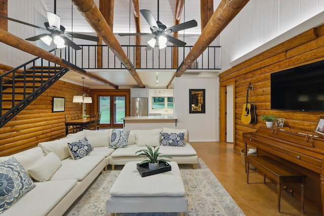 127 Pleasant Valley Ln, Weatherford, TX 76087 - living area featuring a ceiling fan, a towering ceiling, rustic walls, and stairs