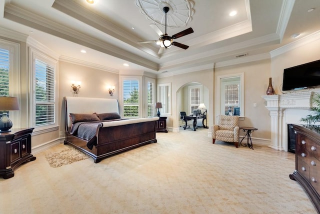 1751 Bison Meadow Ln, Heath, TX 75032 - bedroom with a raised ceiling, multiple windows, arched walkways, a fireplace, and ornamental molding