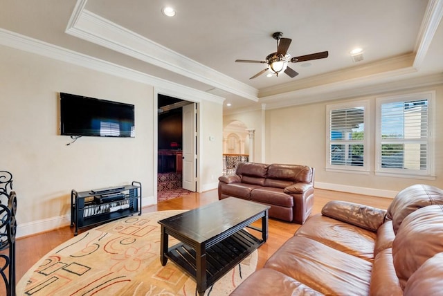 1751 Bison Meadow Ln, Heath, TX 75032 - living room featuring a tray ceiling, light wood-style floors, a ceiling fan, crown molding, and baseboards