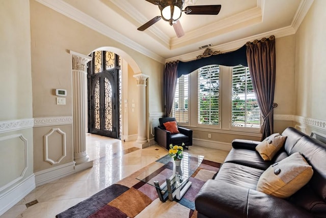 1751 Bison Meadow Ln, Heath, TX 75032 - living room featuring arched walkways, a raised ceiling, ornate columns, crown molding, and a ceiling fan