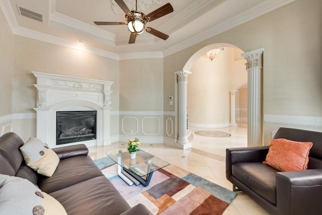 1751 Bison Meadow Ln, Heath, TX 75032 - living area featuring ornate columns, tile patterned floors, arched walkways, a tray ceiling, and ceiling fan