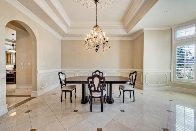 1751 Bison Meadow Ln, Heath, TX 75032 - dining room featuring healthy amount of natural light, arched walkways, a tray ceiling, a chandelier, and crown molding