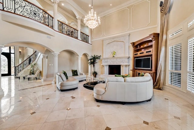 1751 Bison Meadow Ln, Heath, TX 75032 - living area with a high ceiling, arched walkways, decorative columns, a high end fireplace, and stairway
