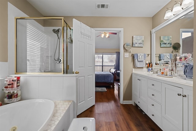 408 Autumn Park Park, Fort Worth, TX 76140 - ensuite bathroom with a ceiling fan, a shower stall, wood finished floors, a whirlpool tub, and vanity