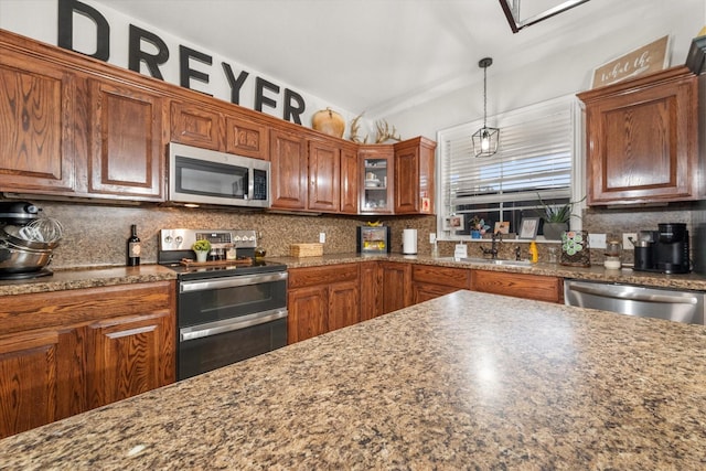 430 Oak Ridge Dr, Fairfield, TX 75840 - kitchen featuring appliances with stainless steel finishes, tasteful backsplash, hanging light fixtures, and brown cabinetry
