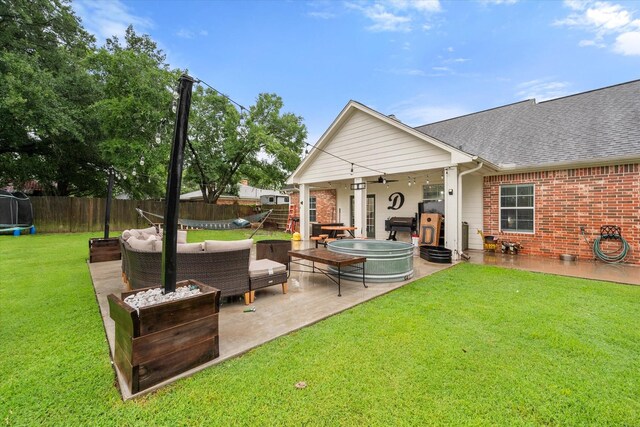 430 Oak Ridge Dr, Fairfield, TX 75840 - back of property with a trampoline, a patio area, brick siding, roof with shingles, and outdoor lounge area