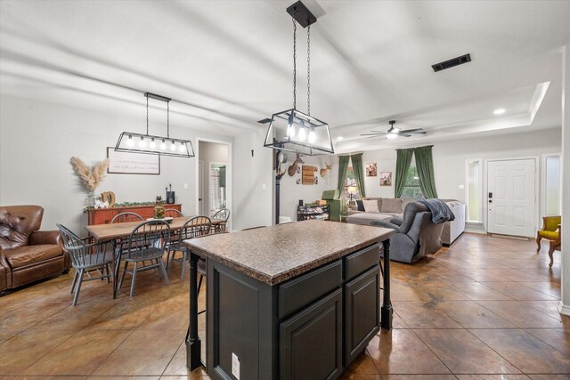 430 Oak Ridge Dr, Fairfield, TX 75840 - kitchen with open floor plan, a center island, ceiling fan, dark tile patterned floors, and a kitchen breakfast bar