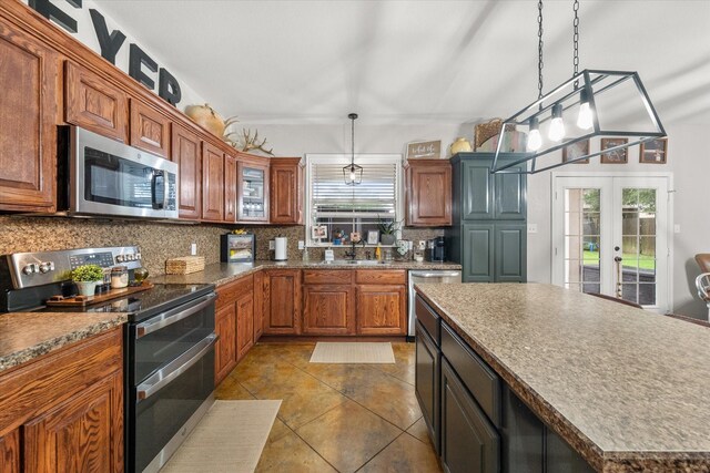 430 Oak Ridge Dr, Fairfield, TX 75840 - kitchen with appliances with stainless steel finishes, backsplash, healthy amount of natural light, and dark tile patterned flooring