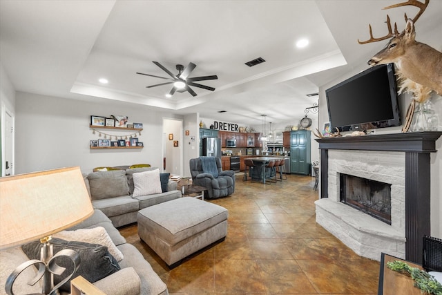 430 Oak Ridge Dr, Fairfield, TX 75840 - living room featuring a tray ceiling, ceiling fan, a stone fireplace, and recessed lighting
