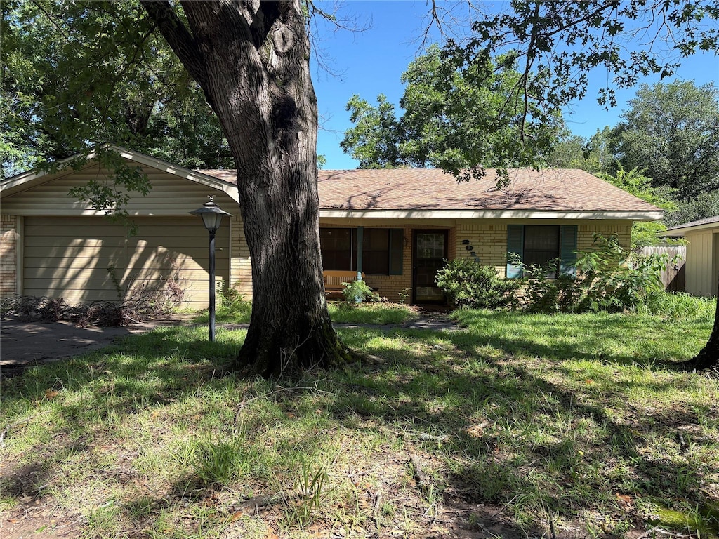 2911 Overlook Cir, Corsicana, TX 75110 - ranch-style house with brick siding, a front yard, and a garage