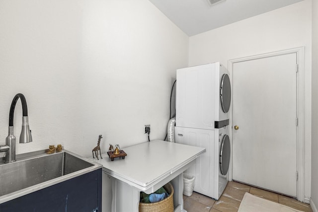 16012 Alvarado Dr, Prosper, TX 75078 - laundry area with stacked washer and clothes dryer and light tile patterned flooring
